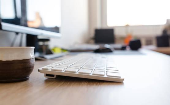 Close up of a desktop focusing on the keyboard