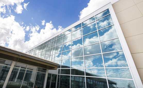 Image of external hospital window reflecting clouds