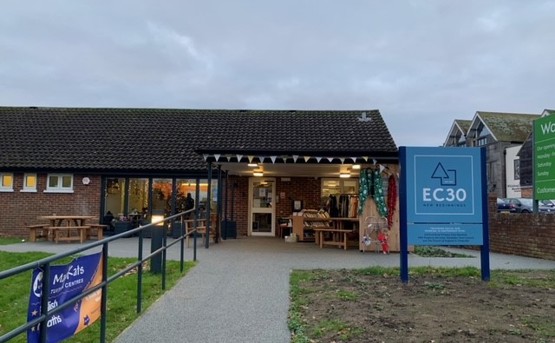 Front of EC30 with large blue sign saying 'EC30' and bunting at the front door