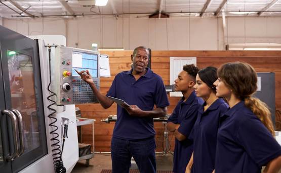 Engineer Instructing Three Apprentices